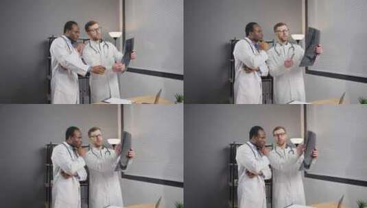 两个穿着白大褂的男人分析X射线图像高清在线视频素材下载