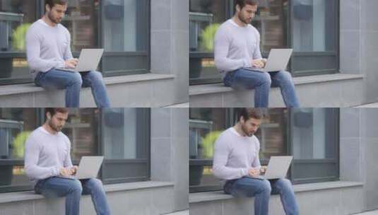 男人兴奋地坐在户外办公高清在线视频素材下载