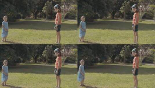 两个小女孩在公园草坪上玩耍高清在线视频素材下载