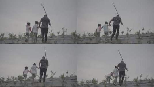 干完农活父亲带着女儿走在乡村田野路上10高清在线视频素材下载