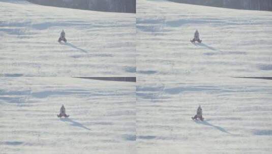 女孩在雪地里骑着雪橇玩耍高清在线视频素材下载
