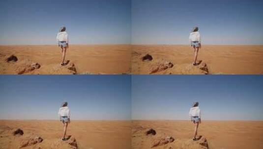 站在沙漠的沙堆上的女人高清在线视频素材下载