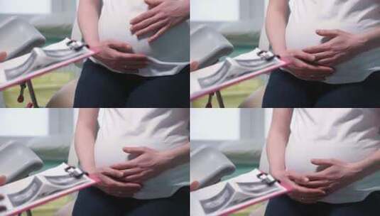 孕妇触摸腹部的特写镜头高清在线视频素材下载