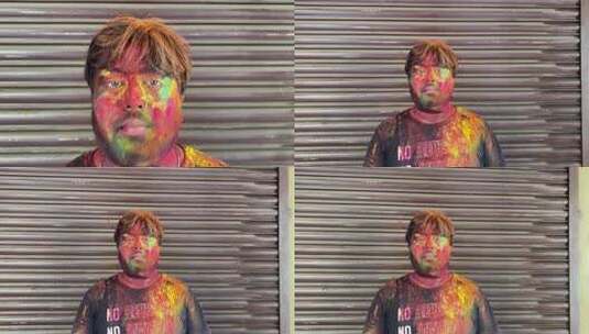 一个印度男孩用彩色庆祝胡里节的特写镜头高清在线视频素材下载