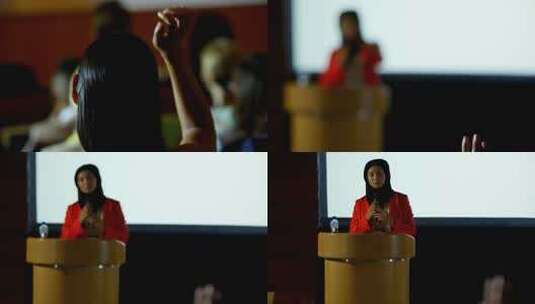成熟的高加索头巾女商人举手在一个商业研讨会高清在线视频素材下载