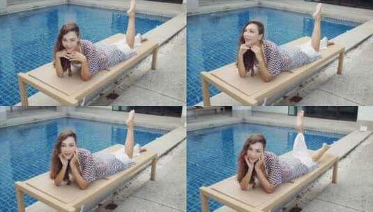 女人在泳池边躺椅趴着高清在线视频素材下载