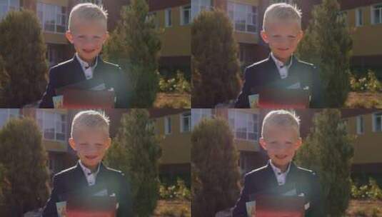 学校附近一个背着背包和书的小男生的肖像高清在线视频素材下载