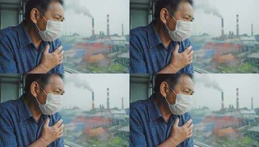 老人戴口罩窗边抚胸望工厂高清在线视频素材下载