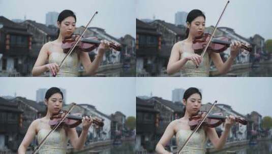 美女在水乡南长街拉小提琴高清在线视频素材下载