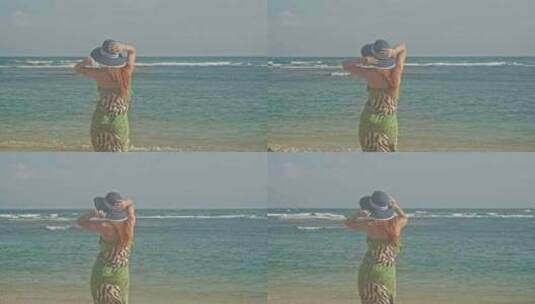 身材妖娆的女孩在独自看海、享受海风和阳光高清在线视频素材下载