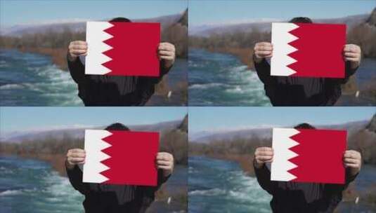 手持巴林国旗旗帜的人高清在线视频素材下载