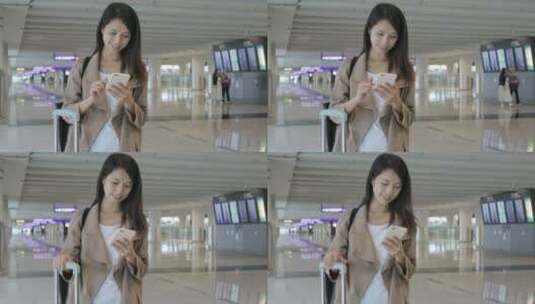 女人在机场大厅用手机高清在线视频素材下载