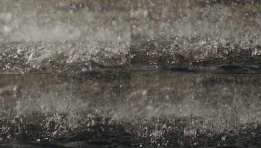 雨水掉落地面溅起水花慢动作特写高清在线视频素材下载