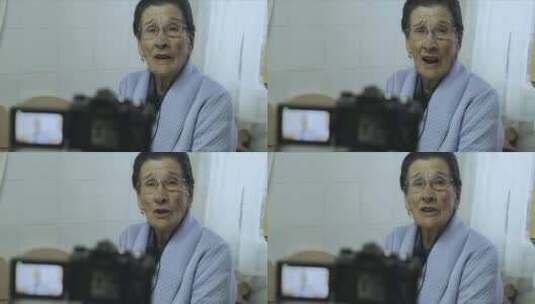老年妇女在摄像机上说话和录音高清在线视频素材下载