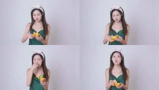 穿着睡衣带发带的女孩吃水果高清在线视频素材下载