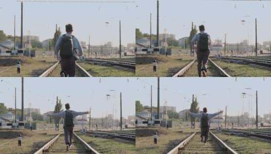 男人张开手臂沿着火车轨道奔跑高清在线视频素材下载