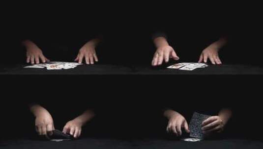 从黑暗中伸出一双玩纸牌的手高清在线视频素材下载