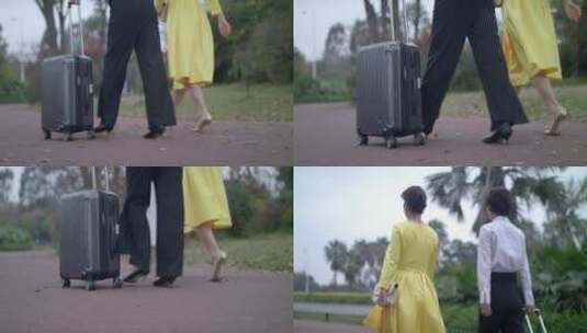 推着行李箱走在路上的女人高清在线视频素材下载