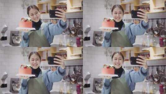 年轻女烘培师托着蛋糕微笑用手机自拍高清在线视频素材下载