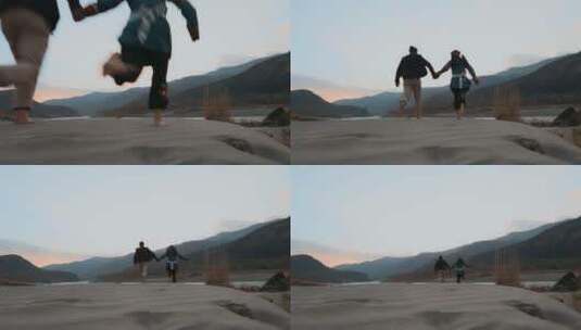 沙滩情侣视频金沙江畔沙滩上奔跑的彝族恋人高清在线视频素材下载