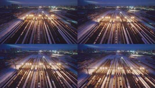中国哈尔滨南站冬季货运火车夜景航拍高清在线视频素材下载