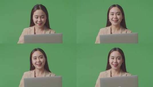 亚洲女商人使用笔记本电脑并在绿屏工作室对着镜头微笑的特写镜头高清在线视频素材下载