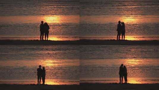 海边沙滩上看金色海面的一对情侣高清在线视频素材下载