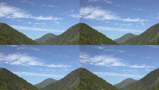 森林覆盖的大山谷上的部分卷云高清在线视频素材下载