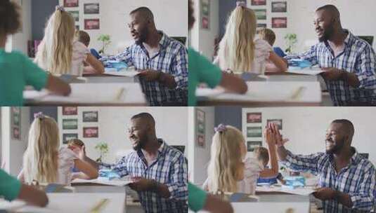 快乐的非裔美国男老师和高加索女孩拍手的视频高清在线视频素材下载