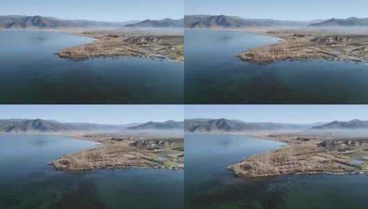 泸沽湖冬季清晨湖面烟雾湖边村落高清在线视频素材下载