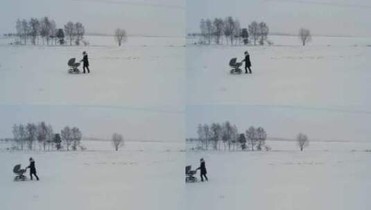 阴沉沉的冬日，单亲母亲推着婴儿车穿过路上高清在线视频素材下载