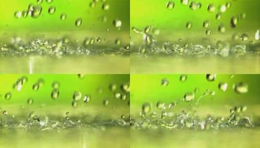 绿色的背景下水滴落下高清在线视频素材下载