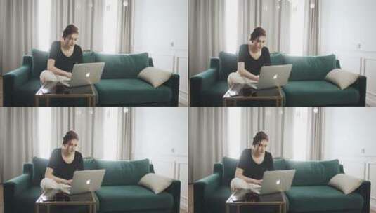 坐在沙发上工作的女人高清在线视频素材下载