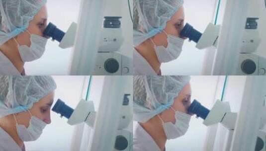 戴着口罩在看显微镜的技术员高清在线视频素材下载