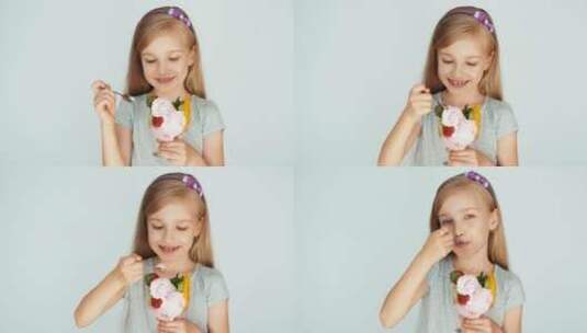 女孩吃着冰淇淋在镜头前微笑高清在线视频素材下载