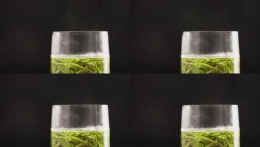 玻璃杯中刚冲泡的绿茶龙井茶高清在线视频素材下载