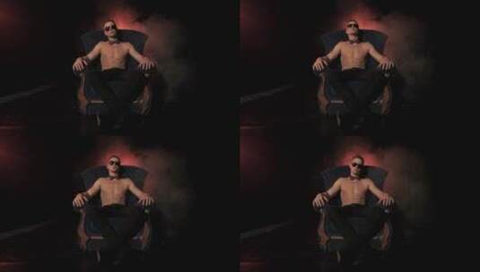 男人赤裸上身坐在烟雾弥漫的扶手椅上高清在线视频素材下载