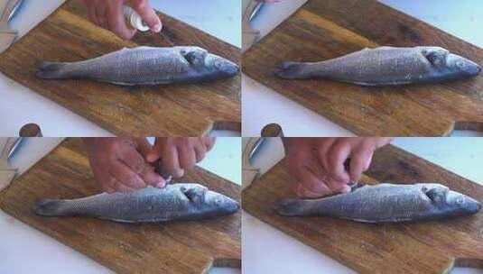 厨师在鱼身上撒盐高清在线视频素材下载