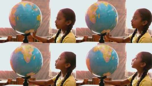 小女孩在教室里看地球仪高清在线视频素材下载