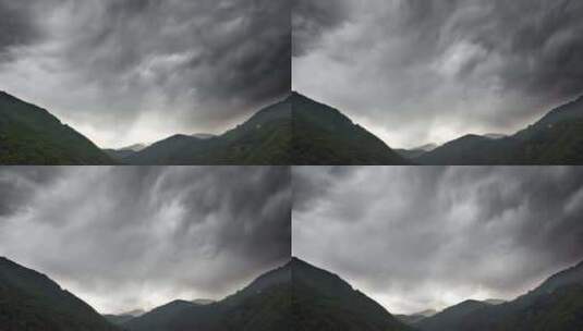 厚厚的黑色云层覆盖着森林山脉之间的山谷高清在线视频素材下载