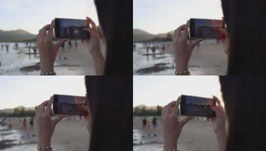 美女在海边用手机录视频高清在线视频素材下载