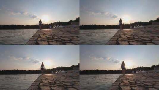 女人赤脚走在海堤上高清在线视频素材下载