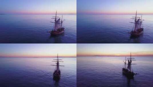 日落时分，一艘高大帆船在开阔的海洋上壮观的航拍高清在线视频素材下载