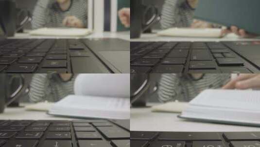 笔记本电脑键盘和两个人看书的滑动特写镜头高清在线视频素材下载