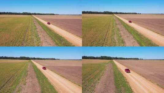 农场地区红色皮卡在土路上行驶的航拍照片高清在线视频素材下载