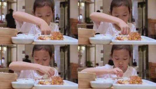 在餐厅大快朵颐的中国女孩高清在线视频素材下载