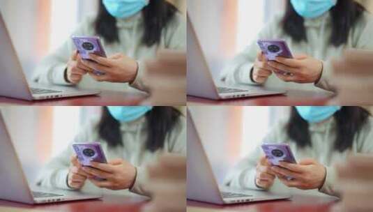疫情带口罩年轻女子在咖啡店使用手机笔记本高清在线视频素材下载