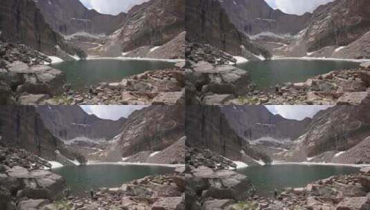 男子徒步山谷湖泊航拍高清在线视频素材下载