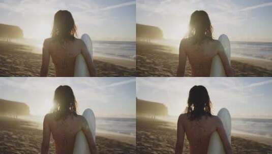 女人拿着冲浪板在海滩高清在线视频素材下载
