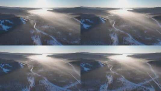 航拍冷空气缭绕的冬季山林冰河高清在线视频素材下载